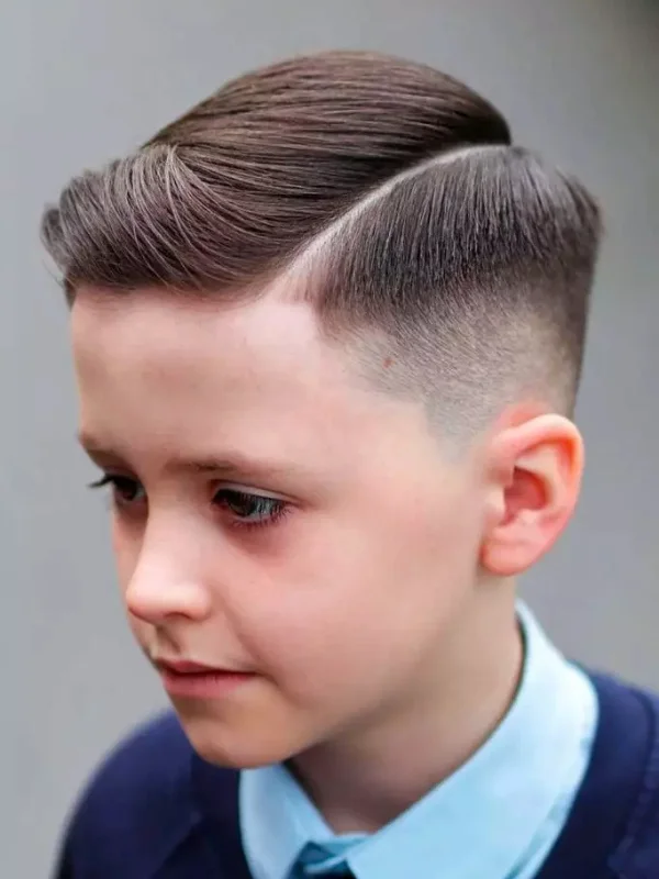 35 Cool & Stylish Kids Boy Haircuts 19 Hard Comb Over with Mid Fade