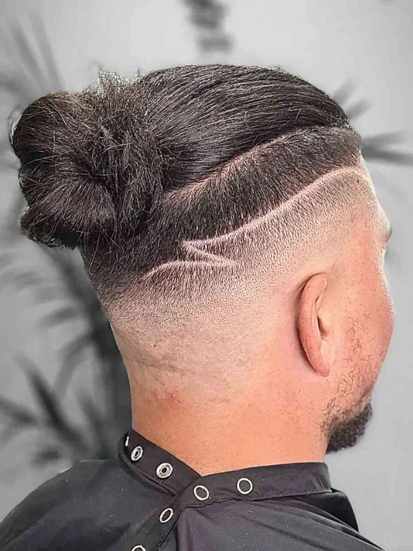 30 Cool Haircut Designs: Creative Ideas for Bold Looks 29 Man Bun with Undercut Fade and Artist Design