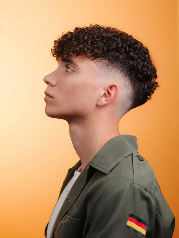 35 Cool Haircuts for Teenage Guys – Trendy & Fresh Styles 12 Short Curly Hair with Low Burst Fade