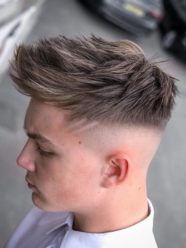 35 Cool Haircuts for Teenage Guys – Trendy & Fresh Styles 8 Textured Short Spiky Hair with Mid Skin Fade